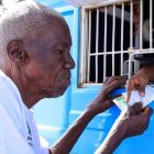 An elderly Ugandan citizen receives money under the Social Assistance Grants for Empowerment (SAGE) in Mbale District on March 8, 2020 PHOTO/DAVID.