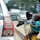A young girl is serving her young baby sister a drop of water as she begs on the expensive streets of the capital city of Kampala.<br />It is unfortunate indeed that these children have been separated from their dear parents and thrown into government camps. And the government is bent on taking these parents to the courts of law because of their poverty to be sentenced to a punishment of imprisonment of over 3 months! What sort of a socialist African government is this. You can never hear of such inhuman deeds done by even the capitalists or communists of this world. Where to be very poor is a crime and to go on the public streets to beg with your family, is to break the law of this poor African country of Uganda!