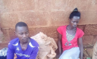 Peter Magoola and his wife, Ruth Mirembe<br />at the police station.<br />One wonders where in the African traditional socialist communities is the modern welfare system? Surely Socialism first started in Africa. One only knows about its promotion as Ujamaa during the rule of Julius Nyerere of Tanzania. One reckons these young parents could not release their child to the neighbors. Certainly no one was interested to help look after such a sick kid for the parents to go and work for a living! Most probably the kid had cerebral malaria. And the parents had not enough money to pay for the national medical treatment. This is where it gets even worse when the crocked pastors come in to provide the unnecessary spiritual treatment!