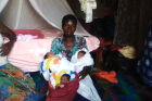 Ms Catherine Akello with her new born triplets.<br />Uganda as a Christian African country has no such thing as a modern social welfare system to assist such vulnerable individuals of the state. But there are many churches and mosques in the country where these religious organizations do not pay tax and yet have annual  budgets of billions of shillings to work with.