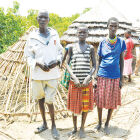 Lina Lokwangiro of school age (c) with her parents sitting for ever at home.