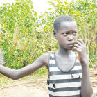 At midday, thick beads of sweat drip from 11-year-old Lina Lokwangiro&rsquo;s brow, as she aids her mother organise straw for roofing their newly-constructed hut.